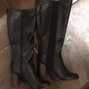Black boot with dark brown heel. Never worn